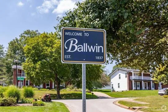 Welcome to Ballwin sign in front of a white historic house