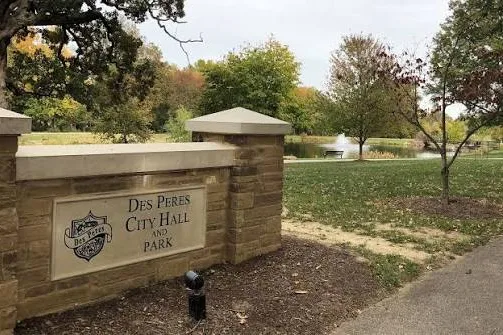 Des Peres City Park entrance sign beside a walking path